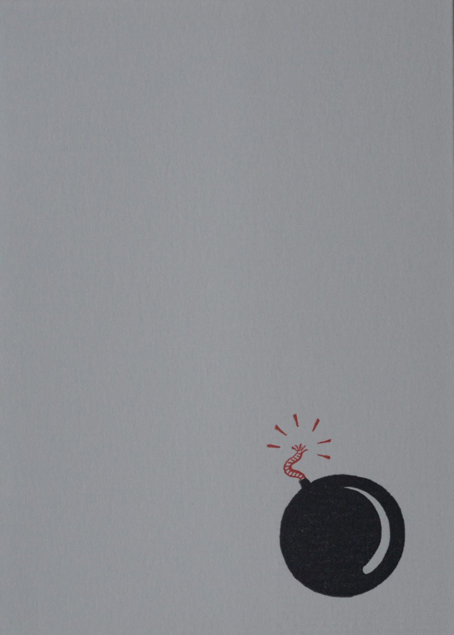 Black bomb illustration with red wick on a gray background